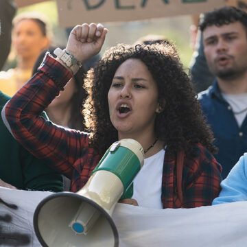 Student Activist Leading Protest with Megaphone The Right Wing’s Institutional Problem