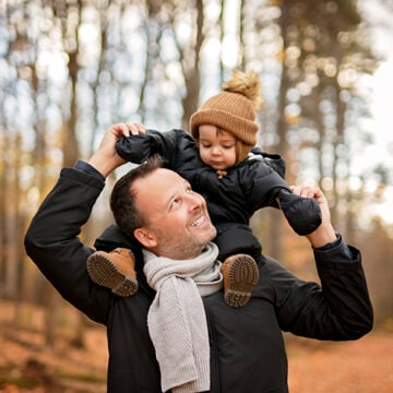 Joyful dad and his little baby. daddy and child have fun, laugh and enjoy nature outdoors at autumn park. Every Child Has a Father