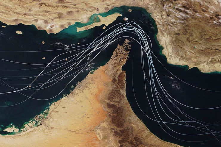 Satellite view of the Strait of Hormuz with white graphic lines representing global shipping lanes and maritime traffic between the Persian Gulf and Gulf of Oman. Strategic oil transport concept Trump Played the Hormuz Hand He Was Dealt