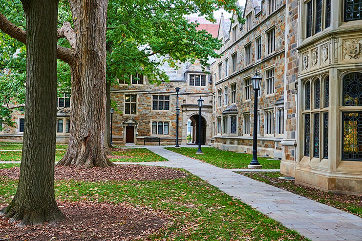 Serene University Campus with Historic Building and Lush Trees Oh, The Humanities: Yet Another Worthless Report on Higher Education