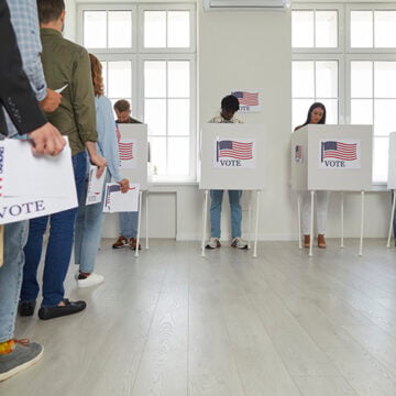 Group of people registering at polling station standing in a queue at vote center. There’s No Room for Whites in Today’s Democratic Party