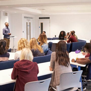 University students study in a classroom with male lecturer Changing College Curricula Is a Winning Issue for Conservatives